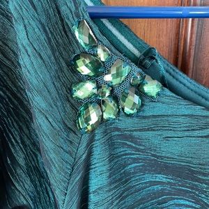 Teal metallic dress, ruched sides, green rhinestone embellishment. Size 16